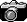 A camera with the lens open and the shutter closed.